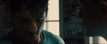 Movie still from “Bleed for This” (2016), directed by Ben Younger – A man's face in front of a window; Close Up shot, Low angle