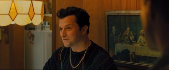 Movie still from “Bleed for This” (2016), directed by Ben Younger – A person wearing a necklace; Medium shot, Over the shoulder angle