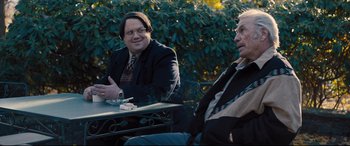 Movie still from “Bleed for This” (2016), directed by Ben Younger – Two men sitting at a table talking to each other; Medium shot, Over the shoulder angle