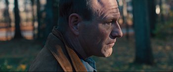 Movie still from “Bleed for This” (2016), directed by Ben Younger – A person wearing a jacket looking to the side; Close Up shot, Over the shoulder angle