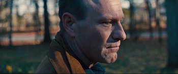 Movie still from “Bleed for This” (2016), directed by Ben Younger – A person wearing a brown jacket; Close Up shot, Over the shoulder angle