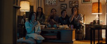 Movie still from “Bleed for This” (2016), directed by Ben Younger – A group of people sitting around a table; Medium shot, High angle