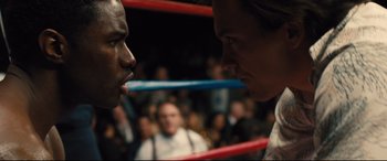 Movie still from “Bleed for This” (2016), directed by Ben Younger – Two people in a boxing ring facing each other; Close Up shot, Over the shoulder angle