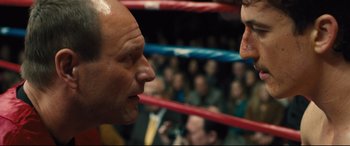 Movie still from “Bleed for This” (2016), directed by Ben Younger – Two people in a boxing ring facing each other; Close Up shot, Over the shoulder angle