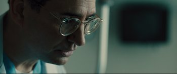 Movie still from “Bleed for This” (2016), directed by Ben Younger – A person wearing glasses; Close Up shot, Over the shoulder angle