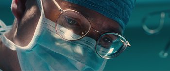Movie still from “Bleed for This” (2016), directed by Ben Younger – A person wearing a surgical mask and glasses; Extreme Close Up shot, Low angle
