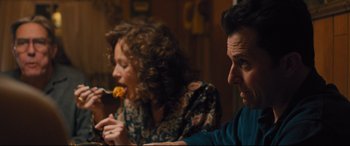 Movie still from “Bleed for This” (2016), directed by Ben Younger – A man and a woman sitting at a table eating food; Medium shot, Over the shoulder angle