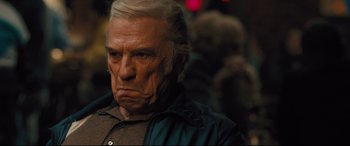 Movie still from “Bleed for This” (2016), directed by Ben Younger – An older man with a frowning look on his face; Close Up shot, Over the shoulder angle
