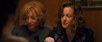 Movie still from “Bleed for This” (2016), directed by Ben Younger – Two women sitting next to each other in a room; Medium shot, Over the shoulder angle