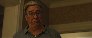Movie still from “Bleed for This” (2016), directed by Ben Younger – An older man with glasses is looking at the camera; Close Up shot, Low angle