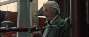 Movie still from “Bleed for This” (2016), directed by Ben Younger – An older man with white hair looking to his left; Close Up shot, Over the shoulder angle