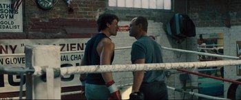 Movie still from “Bleed for This” (2016), directed by Ben Younger – Two men in a boxing ring facing each other; Medium shot, Over the shoulder angle