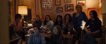 Movie still from “Bleed for This” (2016), directed by Ben Younger – A group of people sitting in a living room; Wide shot, High angle