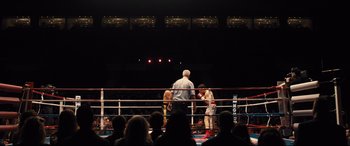 Movie still from “Bleed for This” (2016), directed by Ben Younger – A boxing match in progress in a boxing ring; Extreme Wide shot, High angle