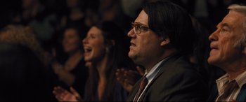 Movie still from “Bleed for This” (2016), directed by Ben Younger – A man and a woman in a crowd of onlookers; Close Up shot, Over the shoulder angle