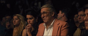 Movie still from “Bleed for This” (2016), directed by Ben Younger – An older man and a younger woman sitting next to each other; Close Up shot, Over the shoulder angle