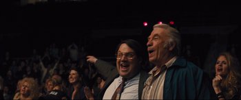 Movie still from “Bleed for This” (2016), directed by Ben Younger – Two men are standing up in a crowd; Medium shot, Low angle