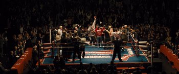 Movie still from “Bleed for This” (2016), directed by Ben Younger – A boxing match in a boxing ring with a crowd of people watching it; Extreme Wide shot, High angle