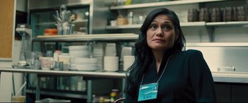 Movie still from “Bleed for This” (2016), directed by Ben Younger – A woman sitting in front of a counter in a kitchen; Close Up shot, Over the shoulder angle