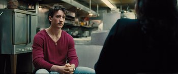 Movie still from “Bleed for This” (2016), directed by Ben Younger – A man sitting in front of another man in a kitchen; Medium shot, Over the shoulder angle