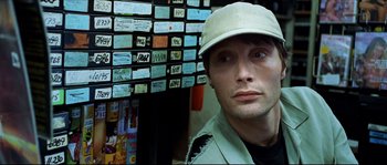 Movie still from “Bleeder” (1999), directed by Nicolas Winding Refn – A person wearing a hat; Close Up shot, Low angle
