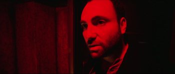 Movie still from “Bleeder” (1999), directed by Nicolas Winding Refn – A person in a red light; Close Up shot, Low angle