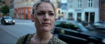 Movie still from “Bleeder” (1999), directed by Nicolas Winding Refn – A person with a car in the background; Close Up shot, Low angle