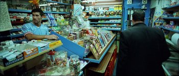 Movie still from “Bleeder” (1999), directed by Nicolas Winding Refn – A grocery store filled with lots of food and drinks; Medium shot, Over the shoulder angle