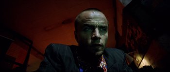 Movie still from “Bleeder” (1999), directed by Nicolas Winding Refn – A person wearing a suit and tie; Close Up shot, Low angle