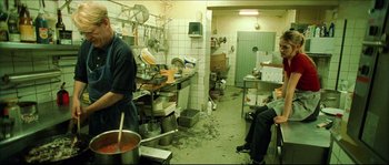 Movie still from “Bleeder” (1999), directed by Nicolas Winding Refn – Two men in a kitchen preparing a meal; Wide shot, High angle