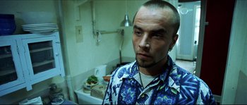 Movie still from “Bleeder” (1999), directed by Nicolas Winding Refn – A person in a room near a sink; Close Up shot, Low angle