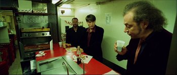 Movie still from “Bleeder” (1999), directed by Nicolas Winding Refn – Two men sitting at a table in front of a mirror; Medium shot, Over the shoulder angle