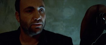 Movie still from “Bleeder” (1999), directed by Nicolas Winding Refn – A person wearing a black shirt; Close Up shot, Low angle