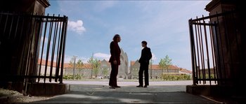 Movie still from “Bleeder” (1999), directed by Nicolas Winding Refn – Two men standing on the side of a road; Extreme Wide shot, Low angle