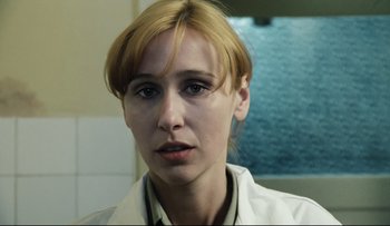 Movie still from “Blind Chance” (1987), directed by Krzysztof Kieslowski – A person wearing a white lab coat; Close Up shot, Low angle