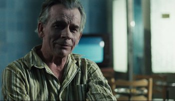 Movie still from “Blind Chance” (1987), directed by Krzysztof Kieslowski – An older man sitting in front of a television; Close Up shot, Over the shoulder angle