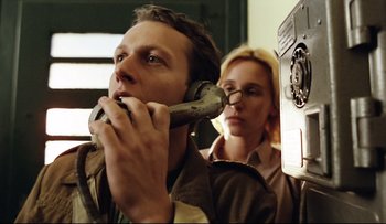 Movie still from “Blind Chance” (1987), directed by Krzysztof Kieslowski – A man holding a wrench in front of a woman's face; Close Up shot, Low angle