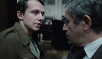 Movie still from “Blind Chance” (1987), directed by Krzysztof Kieslowski – A man and a man standing next to each other; Close Up shot, Over the shoulder angle