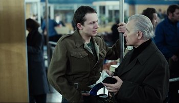 Movie still from “Blind Chance” (1987), directed by Krzysztof Kieslowski – A man talking to another man on a train; Medium shot, Over the shoulder angle