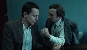 Movie still from “Blind Chance” (1987), directed by Krzysztof Kieslowski – Two men arm wrestling each other on a table; Close Up shot, High angle
