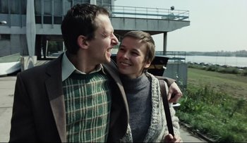 Movie still from “Blind Chance” (1987), directed by Krzysztof Kieslowski – A man and a woman are hugging and laughing; Medium shot, Low angle