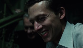 Movie still from “Blind Chance” (1987), directed by Krzysztof Kieslowski – A person smiling; Close Up shot, Over the shoulder angle