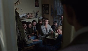Movie still from “Blind Chance” (1987), directed by Krzysztof Kieslowski – A group of people sitting around a table; Medium shot, Over the shoulder angle