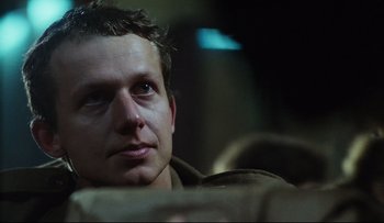 Movie still from “Blind Chance” (1987), directed by Krzysztof Kieslowski – A person sitting in a chair; Close Up shot, Low angle