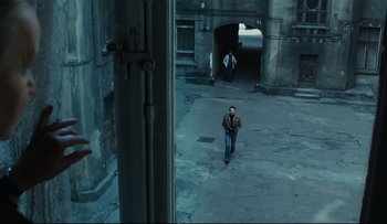 Movie still from “Blind Chance” (1987), directed by Krzysztof Kieslowski – A man is walking down the street with a skateboard; Wide shot, High angle