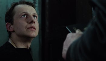 Movie still from “Blind Chance” (1987), directed by Krzysztof Kieslowski – A man is looking up at a man holding a knife; Close Up shot, Low angle