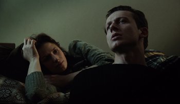 Movie still from “Blind Chance” (1987), directed by Krzysztof Kieslowski – A man and a woman sitting next to each other on a couch; Close Up shot, Low angle