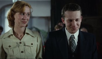 Movie still from “Blind Chance” (1987), directed by Krzysztof Kieslowski – A man and a woman standing next to each other; Medium shot, Over the shoulder angle