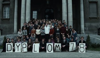 Movie still from “Blind Chance” (1987), directed by Krzysztof Kieslowski – A large group of people standing in front of a building; Wide shot, High angle