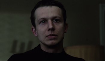 Movie still from “Blind Chance” (1987), directed by Krzysztof Kieslowski – A person wearing a black shirt; Close Up shot, Low angle